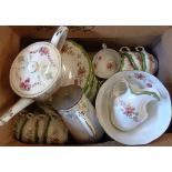 A floral decorated tea set, retailed by Harrods - sold with a teapot and hot water jug