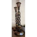 A pair of 1920's Indian painted wood open twist candlesticks in black with floral patterning all