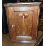 A 9 1/4" Arts & Crafts inlaid polished oak miniature corner cabinet