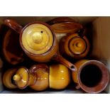 A box containing various treacle glazed items of Torquay Pottery