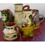 Four Torquay Pottery conical jugs - sold with a Longpark jug