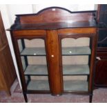 A 3' 9" Edwardian inlaid mahogany and strung display cabinet with low raised back and material lined