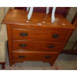 A 33" Edwardian satin walnut chest of three long graduated drawers, set on bracket feet - from a