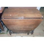 A 36" 20th Century oak gateleg table, set on turned supports