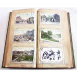 A green postcard album containing a collection of early to mid 20th Century postcards, including
