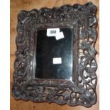 An early 20th Century Chinese ornate hardwood framed bevelled oblong wall mirror with pierced air