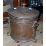 A copper coal bin with scoop