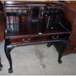A 3' 5" reproduction stained Eastern hardwood writing table with ornate bureau style fitted drawers,