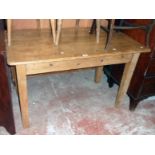 A 4' old waxed pine kitchen table with drawer to one end, set on square tapered legs