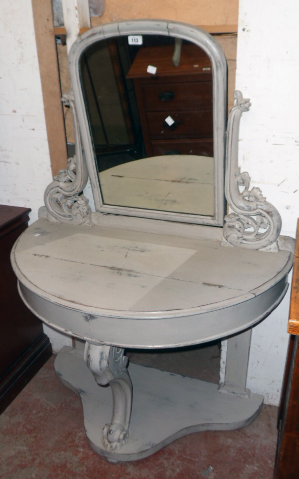 A 3' 3" painted wood demi-lune console dressing table with arched plate, flanking pierced foliate