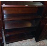 A 35" vintage stained wood sectional four shelf open bookcase