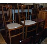 An Edwardian walnut and strung elbow chair, with studded upholstery to seat and square tapered front