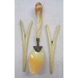 A spoon carved from a large cone or spiral seashell, with white metal moth mount - sold with a