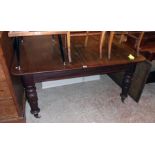 An early Victorian mahogany draw-frame extending dining table with central leaf, set on heavy