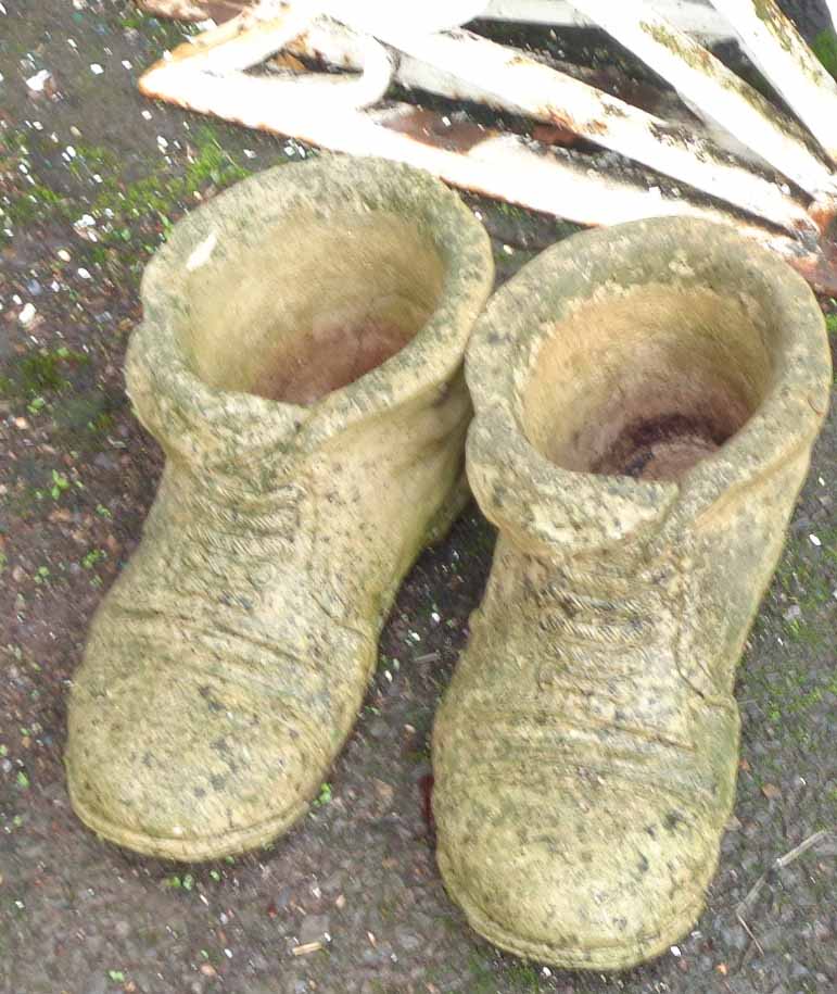 A pair of concrete garden boot pattern planters