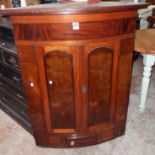 A 3' 3" 19th Century wall mounted bow front corner cupboard with adapted interior enclosed by a pair