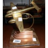 A mid 20th Century brass and copper model of a twin-engine aircraft on Art Deco style base