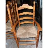 A set of eight 20th Century stained pine framed ladder back dining chairs, with woven rush seats,