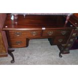 A 3' 6" 20th Century mahogany knee-hole desk in the antique style with two frieze drawers and two