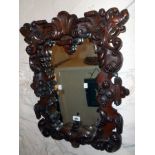 A 19th Century ornate heavily carved and pierced mahogany framed oblong wall mirror with acanthus