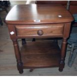 An 18 1/2" Ercol polished elm two tier bedside table with drawer and turned supports