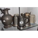 A small collection of various pewter and other tankards