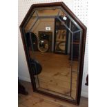 A modern polished wood and leaded framed wall mirror with canted oblong plate