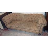 A 6' 6" late Victorian Chesterfield settee with button-back repeat pattern floral upholstery, set on