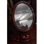 A Victorian stained wood platform dressing table mirror with oval plate, pierced scroll supports and