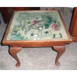 A 20 1/2" 20th Century stained beech tea table with a hunting scene woolwork panel under glass to