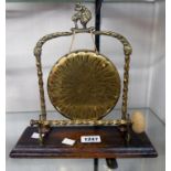 A brass dinner gong with matching striker