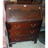 A 29 1/2" 20th Century flame mahogany veneered bureau, with blind fretwork decoration, part fitted