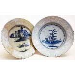 A pair of Bristol Delft shallow dishes with central blue scene decoration and white feathered floral