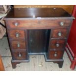 A 31" 19th Century stained mahogany knee-hole desk with frieze drawer, central cupboard and six