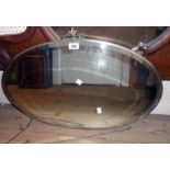 A 1930's gilded metal framed bevelled oval wall mirror