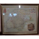 A framed reproduction coloured map print of Devonshire