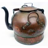 An outsized antique copper kettle with swing handle and retaining lugs to base
