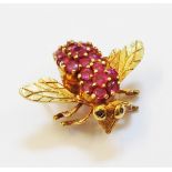 A 1 1/8" wingspan marked 18k yellow metal bee pattern brooch, the thorax and abdomen encrusted