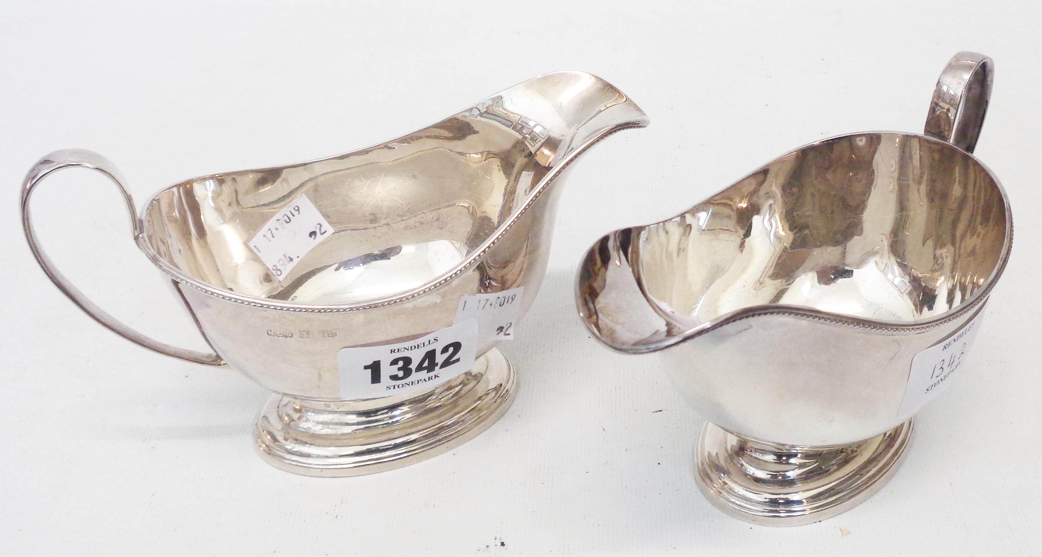A pair of silver sauce boats each with beaded rim and cast pedestal foot - Birmingham 1960
