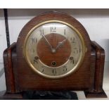 A 1930`s oak cased mantel clock with eight day chiming movement