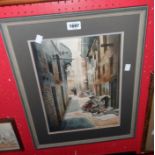 Prabir: a framed watercolour depicting a back street scene with women doing laundry - signed and