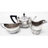 A three piece silver tea set of semi-reeded design with small teapot - William Hutton & Sons Ltd.,