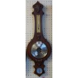 A vintage Weathermaster carved oak cased banjo barometer/thermometer with visible aneroid works to