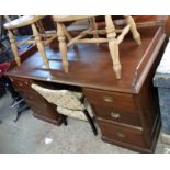 A 5' 3" Victorian stained walnut twin pedestal desk with a low moulded gallery and six flanking
