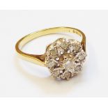 A hallmarked 750 gold diamond cluster ring