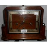 An Art Deco polished oak cased mantel clock with English eight day chiming movement