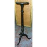 An early 20th Century stained walnut jardinière stand with decorative pillar and tripod base