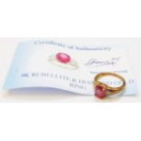 A marked 375 gold ring, set with central oval rubellite flanked by tiny diamonds with certificate