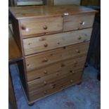 A 33" modern waxed pine chest of two short and five long drawers, set on turned bun feet