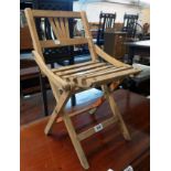 A vintage child's folding chair with slatted seat panel